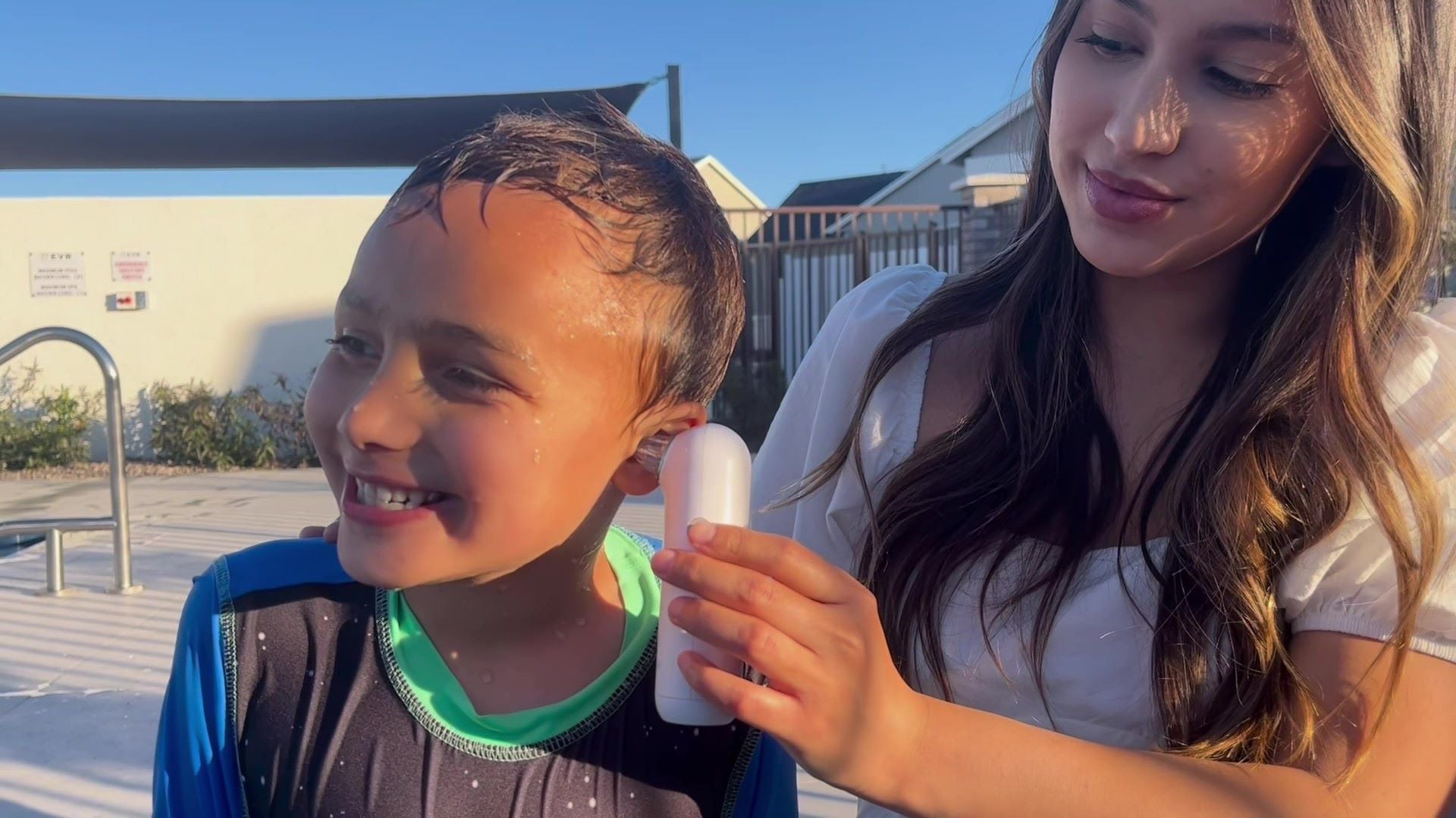 Load video: Video of mom using Whisper ear dryer to remove water stuck in ear for her kid, and prevent swimmer&#39;s ear infection